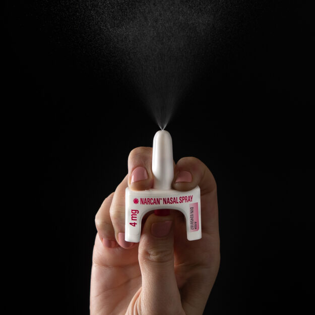 NNS sprayer in hand, NARCAN® Nasal Spray